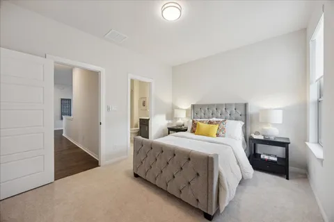 a bedroom with a bed and a lamp