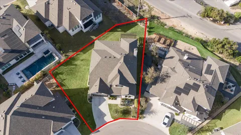 aerial view of a house with a yard