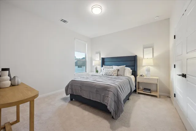 a bedroom with a bed and a lamp