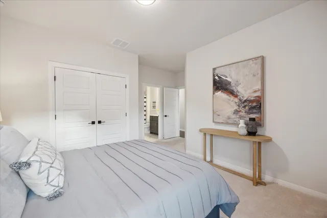 a bedroom with a bed and a painting on the wall