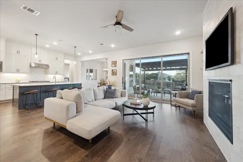 a living room with fireplace furniture and a flat screen tv