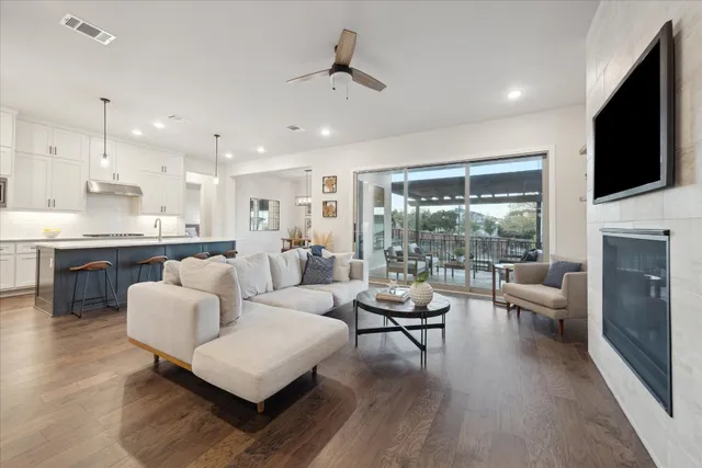 a living room with fireplace furniture and a flat screen tv