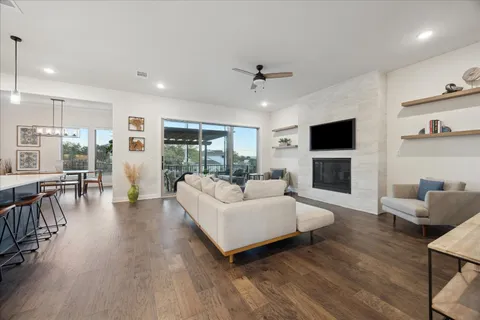 a living room with furniture a fireplace and a flat screen tv