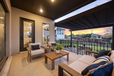a view of a patio with a table chairs and a backyard