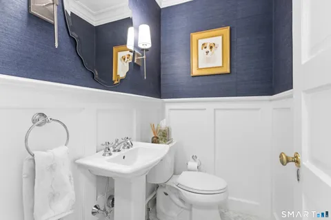 a bathroom with a toilet sink and mirror
