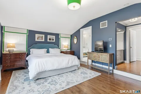 a bedroom with a bed and a table