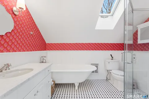 a bathroom with a sink toilet vanity and shower