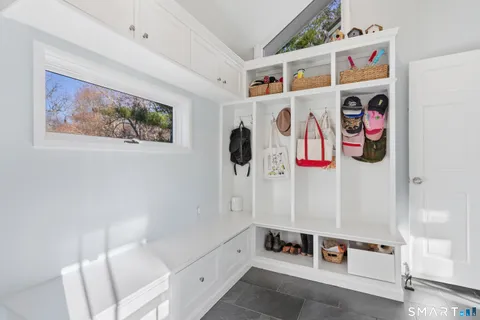 a white bath tub sitting next to a white wall