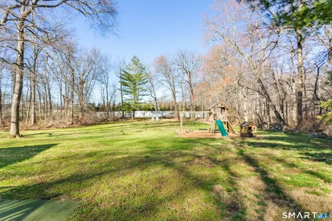 a view of swimming pool with outdoor seating and trees