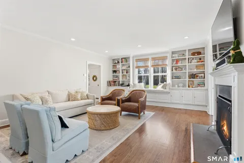 a living room with furniture fireplace and flat screen tv