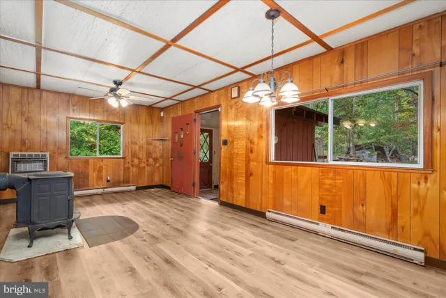 a view of a backyard with wooden floor and iron stairs