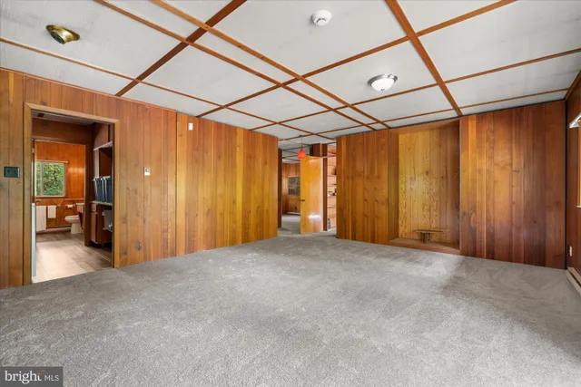 a view of empty room with wooden walls