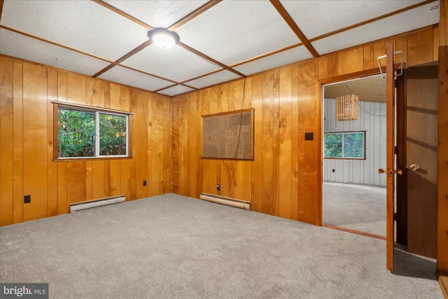 an empty room with windows and closet