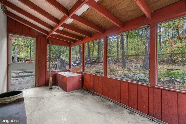 a room with furniture and large windows