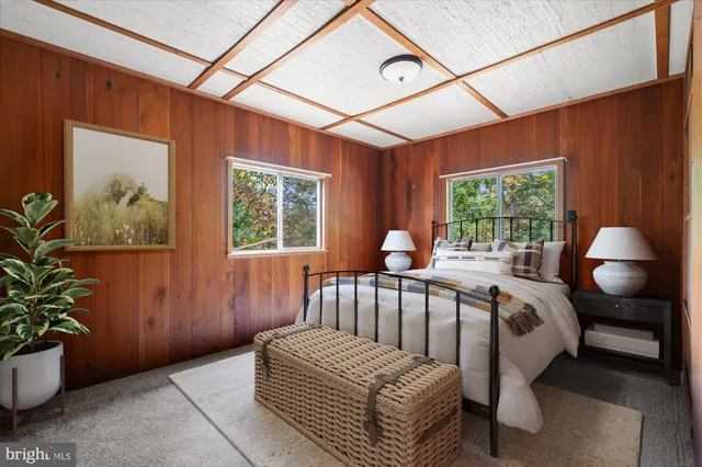 a bedroom with a large bed and a potted plant