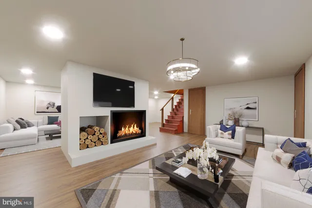 a living room with furniture and a fireplace with wooden floor