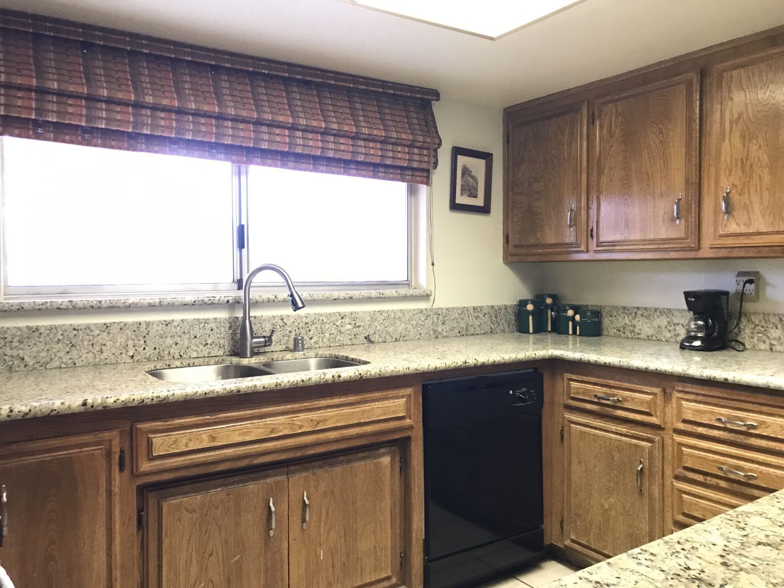 232 Apache Lane Ridgecrest, CA 93555 - Photo 3 of 19 a kitchen with granite countertop a sink and a window