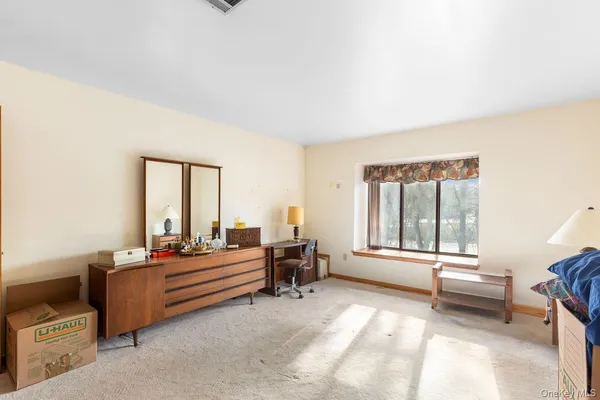 a bedroom with furniture and a window