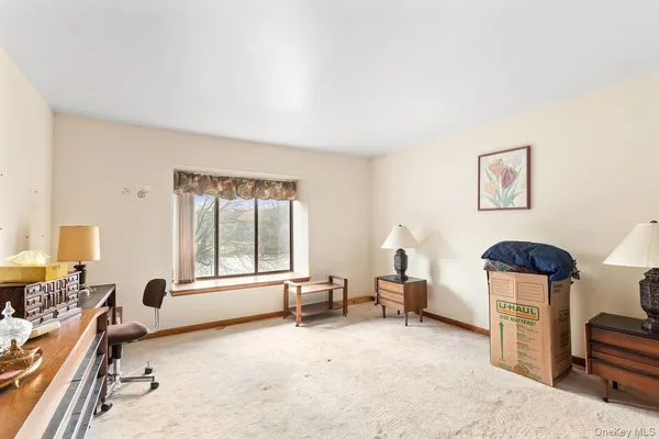 a living room with furniture gym equipment and a large window