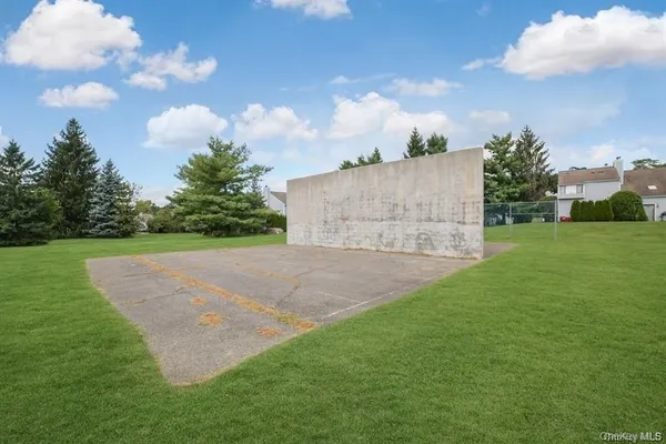 an aerial view of residential houses with outdoor space and trees