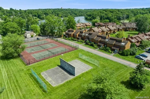 an aerial view of a house with a yard and lake view