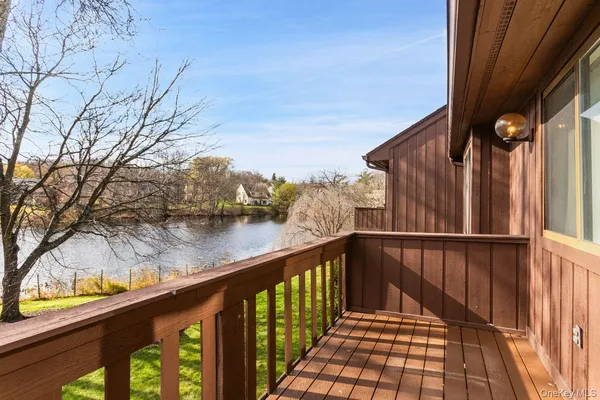 a view of balcony with wooden floor and fence