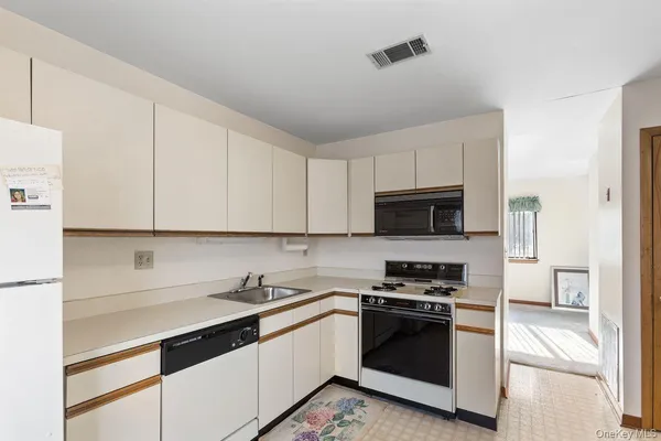 a kitchen with a sink and steel appliances