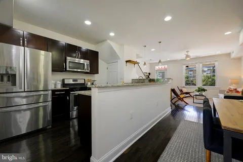 a kitchen with stainless steel appliances a refrigerator stove microwave and cabinets