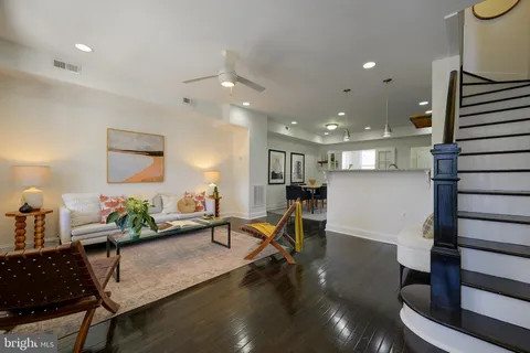 a living room with furniture and wooden floor