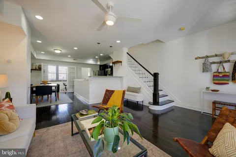 a living room with furniture and kitchen view