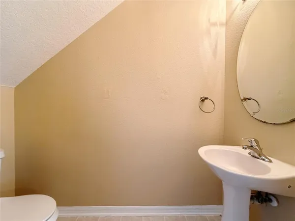 a bathroom with a sink a toilet and mirror