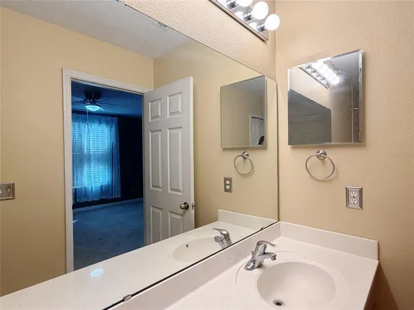 a bathroom with a sink and a large mirror