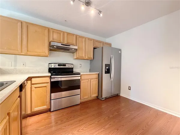 a kitchen with stainless steel appliances a stove microwave and cabinets