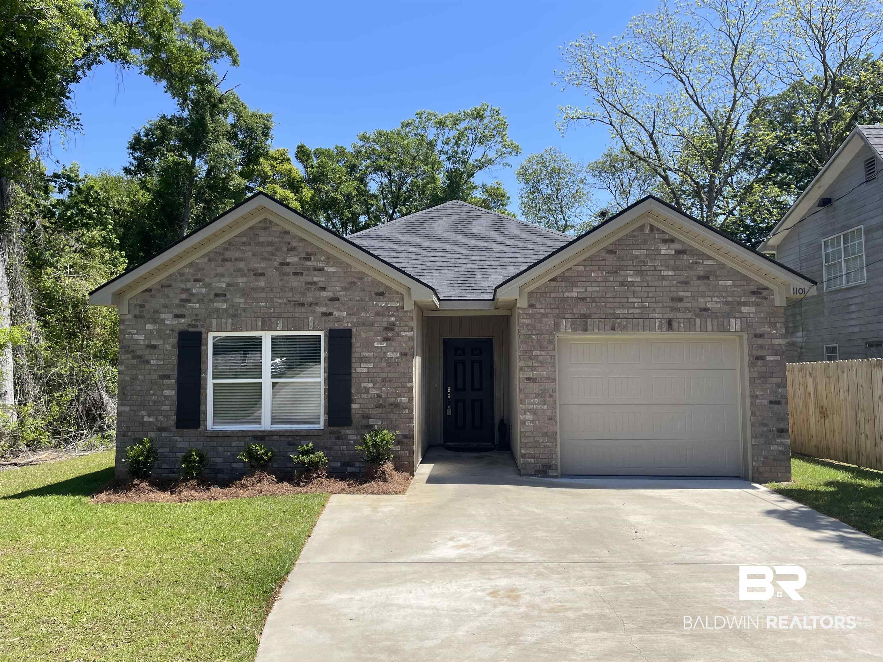 1101 Pinemont Drive Mobile, AL 36609 - Photo 1 of 18 Single story home featuring fence, concrete driveway, brick siding, a front yard, and a garage