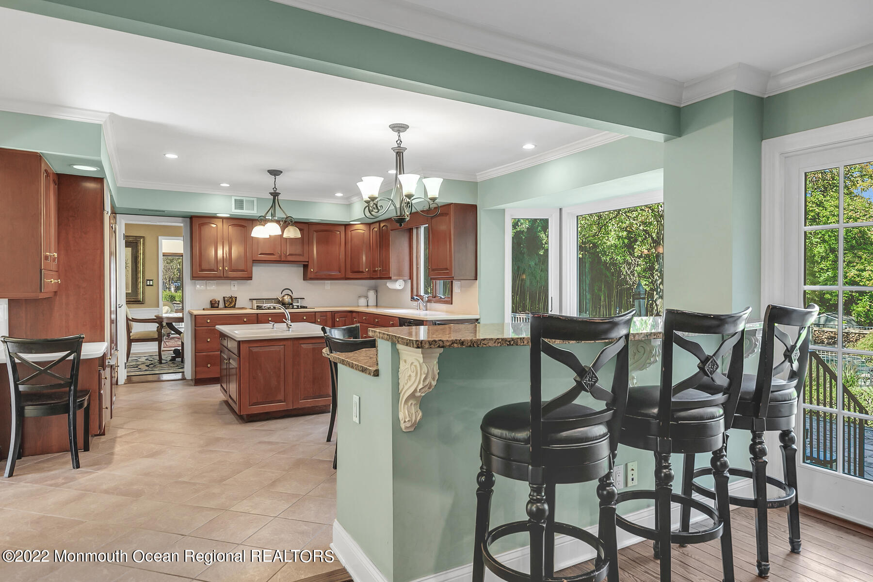 25 Spring Garden Avenue Colts Neck, NJ 07722 - Photo 12 of 58 a kitchen with a dining table chairs stainless steel appliances and cabinets