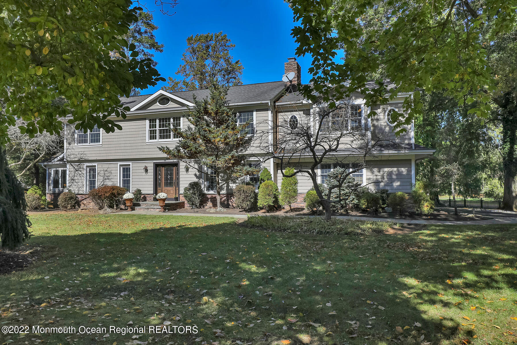 25 Spring Garden Avenue Colts Neck, NJ 07722 - Photo 57 of 58 a front view of a residential apartment building with a yard