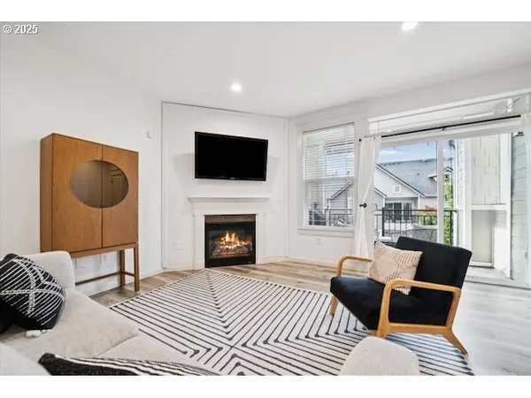 a living room with furniture a fireplace and a flat screen tv