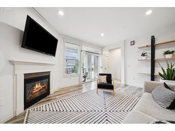a view of an empty room with chandelier fan
