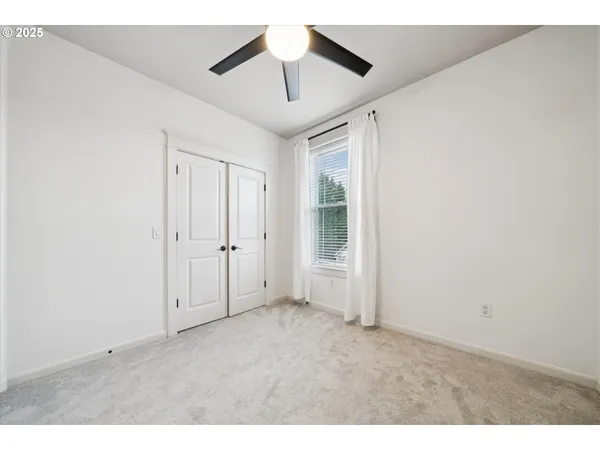 a bedroom with a bed tv and a fireplace