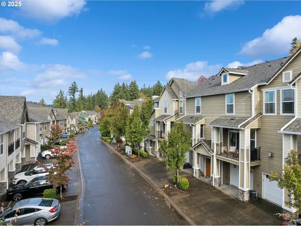 a living room with furniture a fireplace and a wall painting