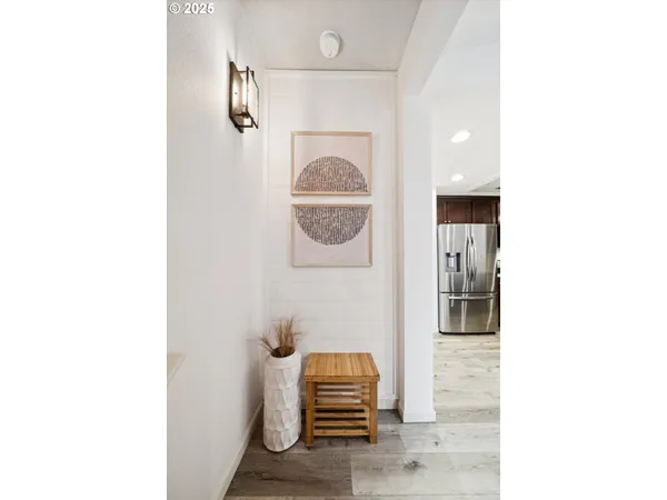 a front view of a room with painting and a clock