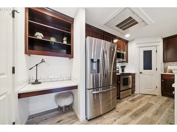 a kitchen with a refrigerator and a sink