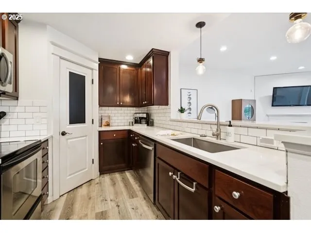 a kitchen with a sink and a refrigerator
