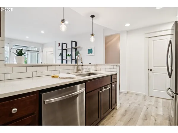 a living room with stainless steel appliances kitchen island granite countertop furniture and a kitchen view