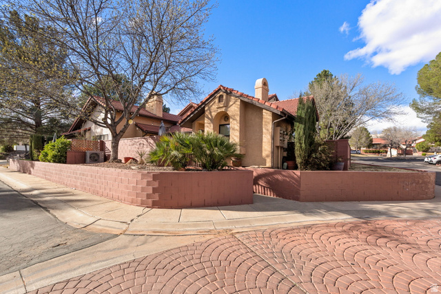 301 South 1200th Street East, Unit 31 St. George, UT 84790 - Photo 2 of 21 View of side of property with a tile roof, stucco siding, and a chimney