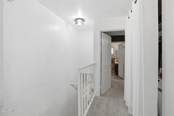 a view of a hallway with a white walls