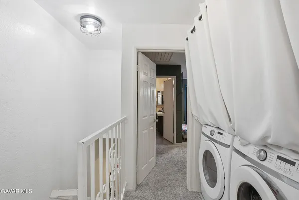 a view of a hallway with washer and dryer
