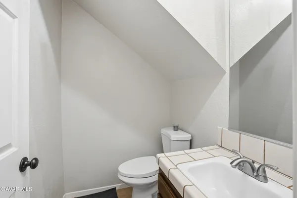 a white toilet sitting next to a bathroom sink
