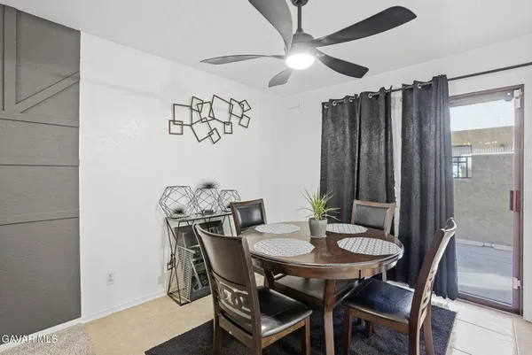 a view of a dining room with furniture and chandelier