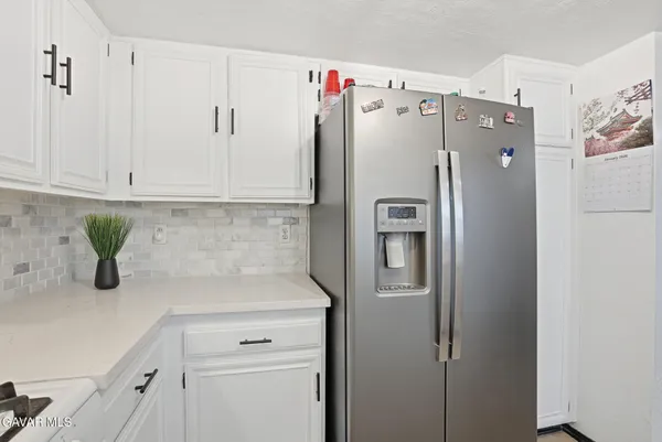 a white refrigerator freezer sitting in a kitchen